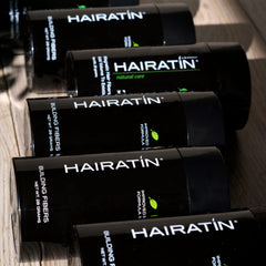 HAIRATIN user brushing hair after applying for a finished style.
