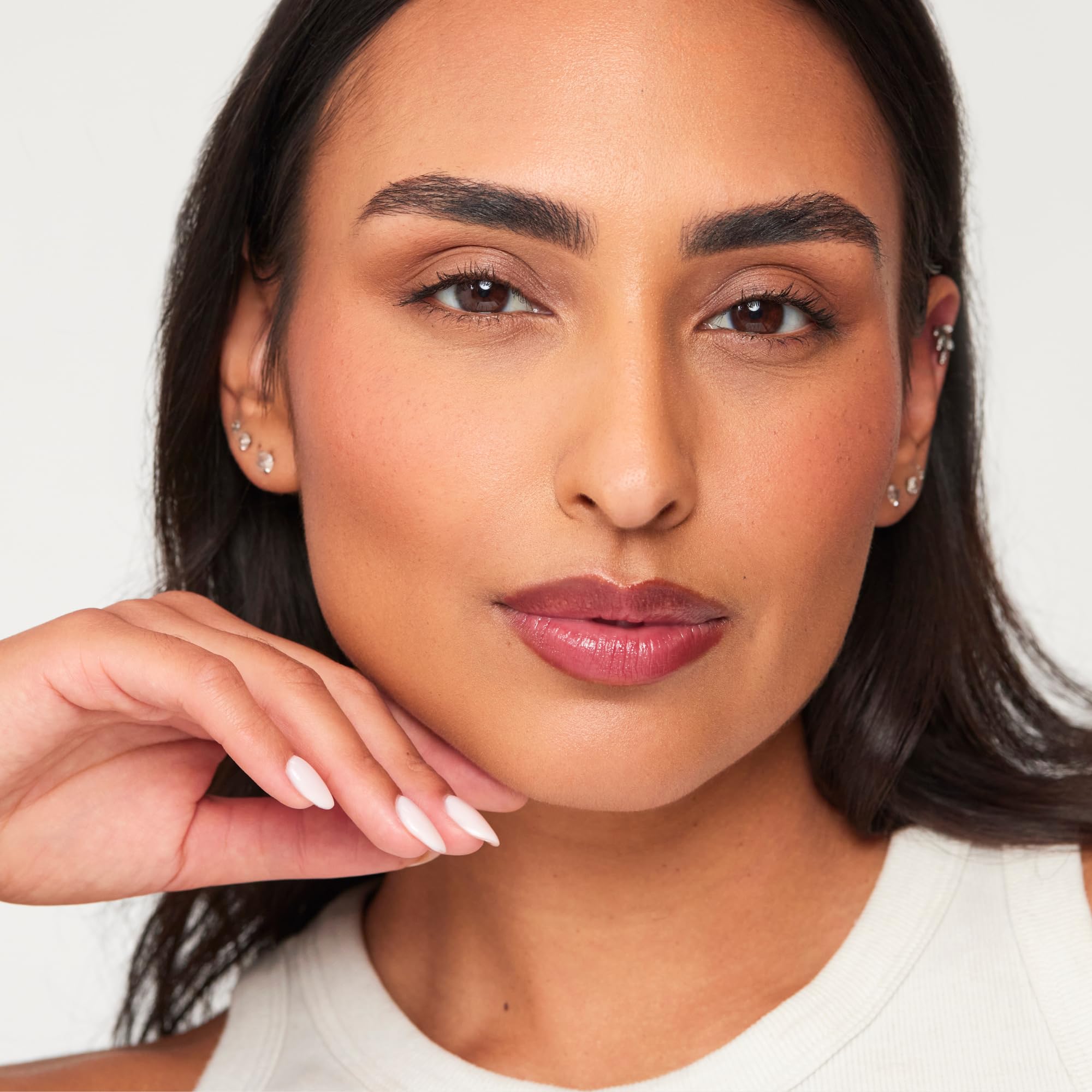 HALEYS Re-Pair lip balm in hand for on-the-go touchups.
