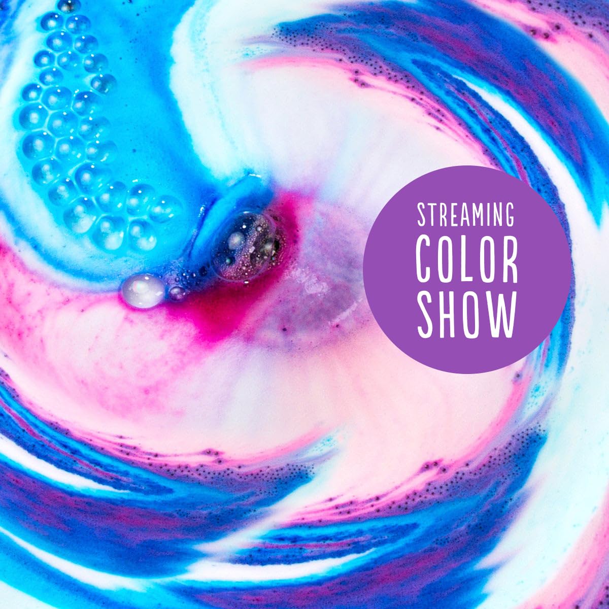 Hallu Unicorn Bath Bomb creates a vibrant pink and purple color swirl.