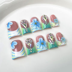 10Pcs Blue Flower Press On Nails in duckbill shape for comfortable all-day wear.