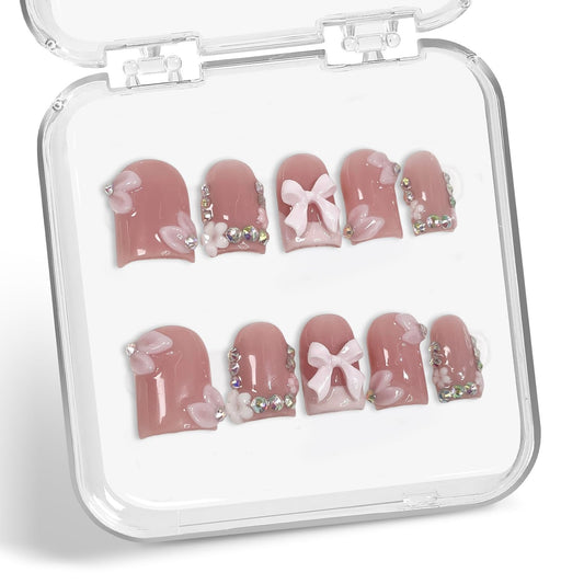 Handmade press-on nails with a 3D bow, ideal for elegant events.
