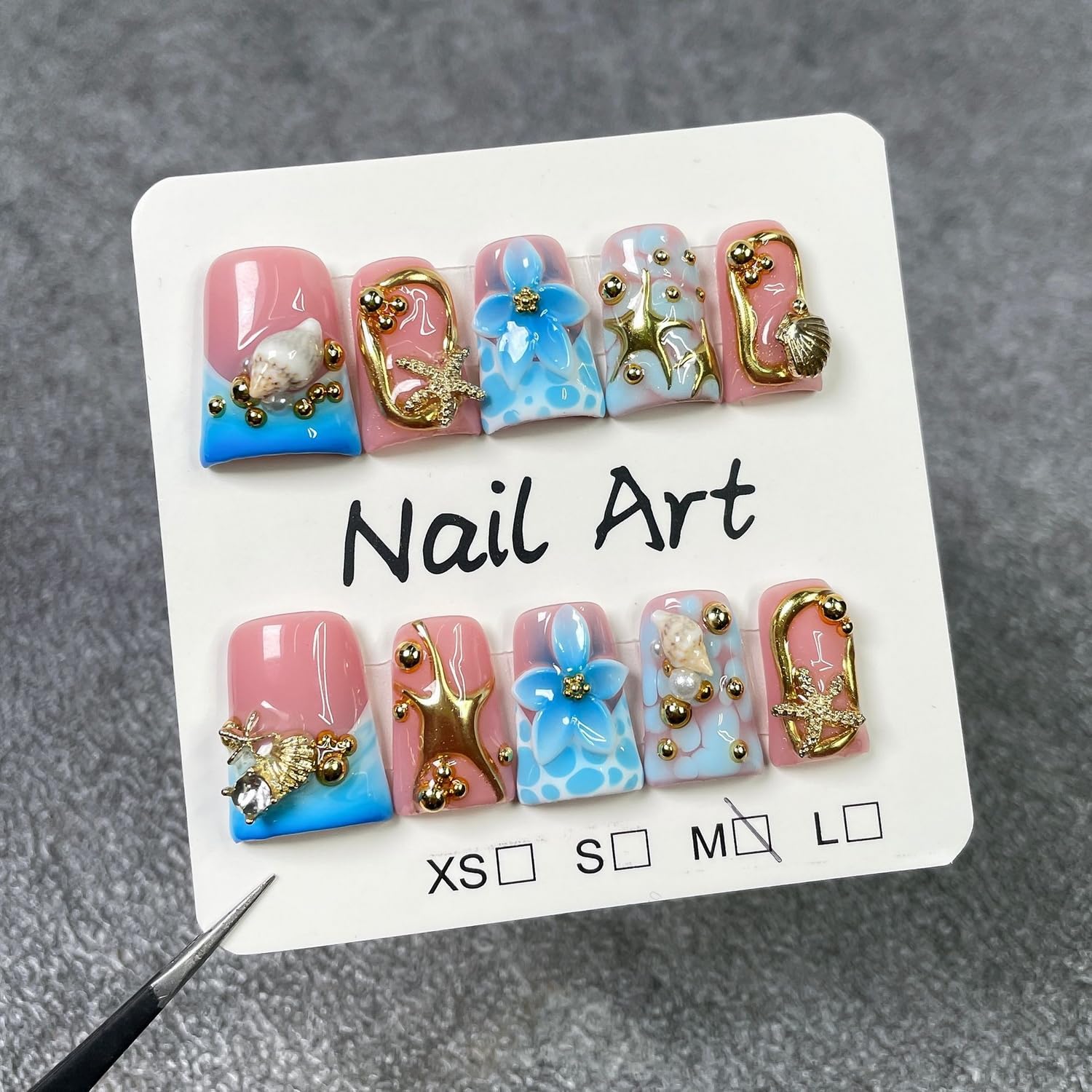 Handmade press-on nails featuring blue flower embossing for chic daytime wear.