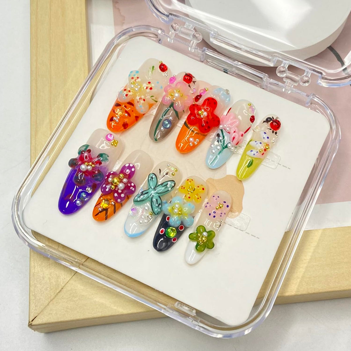 Handmade press-on nails with colorful flower design for a vibrant at-home manicure.
