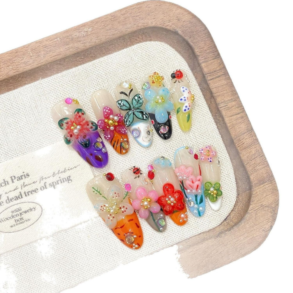 Handmade press-on nails close-up of flower rhinestones and shine.