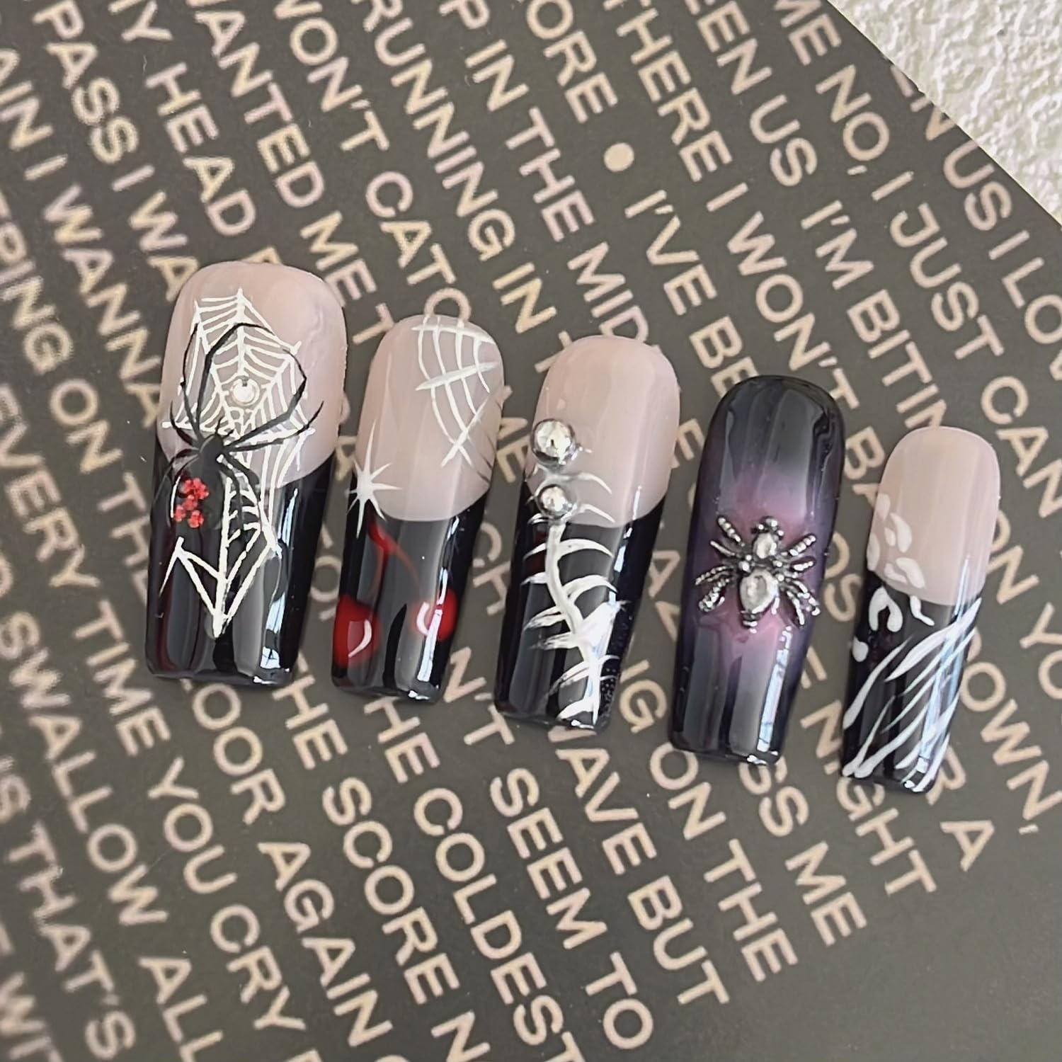 Handmade press-on nails Halloween art spider pattern for festive nail art.