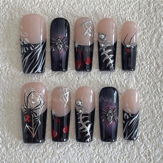 Handmade press-on nails with spider detail close-up for bold costume-ready nails.