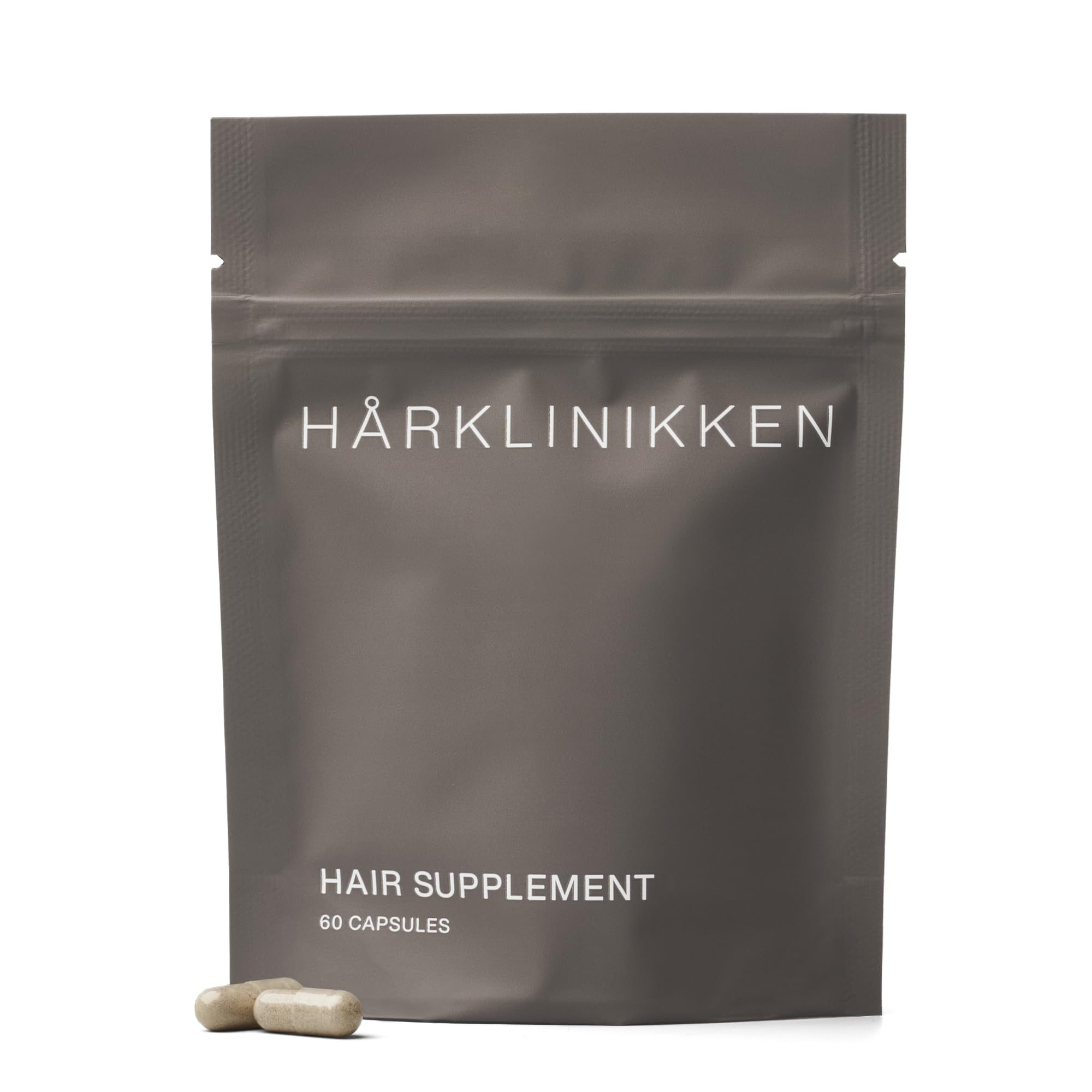 Harklinikken Hair Supplement bottle close-up showing vegan capsules for fuller-looking hair.
