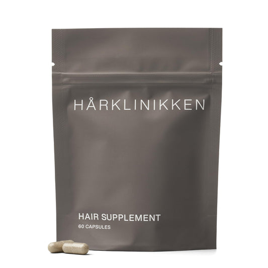 Harklinikken Hair Supplement bottle close-up showing vegan capsules for fuller-looking hair.