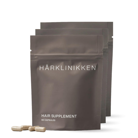 Harklinikken hair supplement bottle with capsules for daily use.