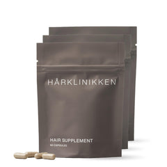 Harklinikken hair supplement bottle with capsules for daily use.