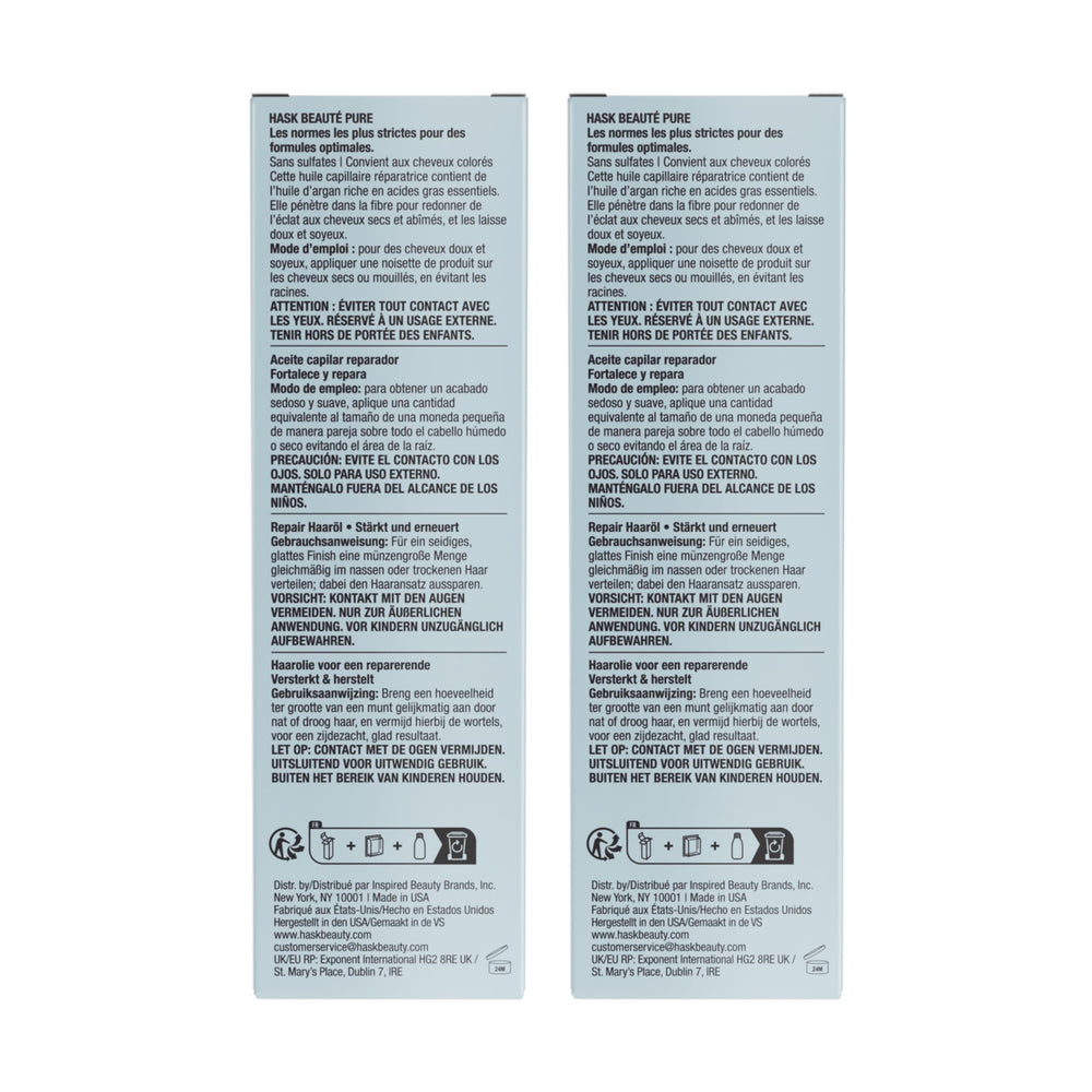 HASK Argan Repairing Hair Oil on dresser with two vials ready