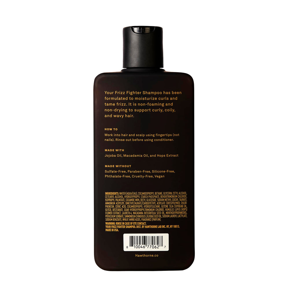Man using Hawthorne Frizz Fighter Shampoo for curly hair care.