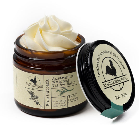 Hearth and Homestead Blue Outback Balm bottle close-up showing soothing, all-natural formula.