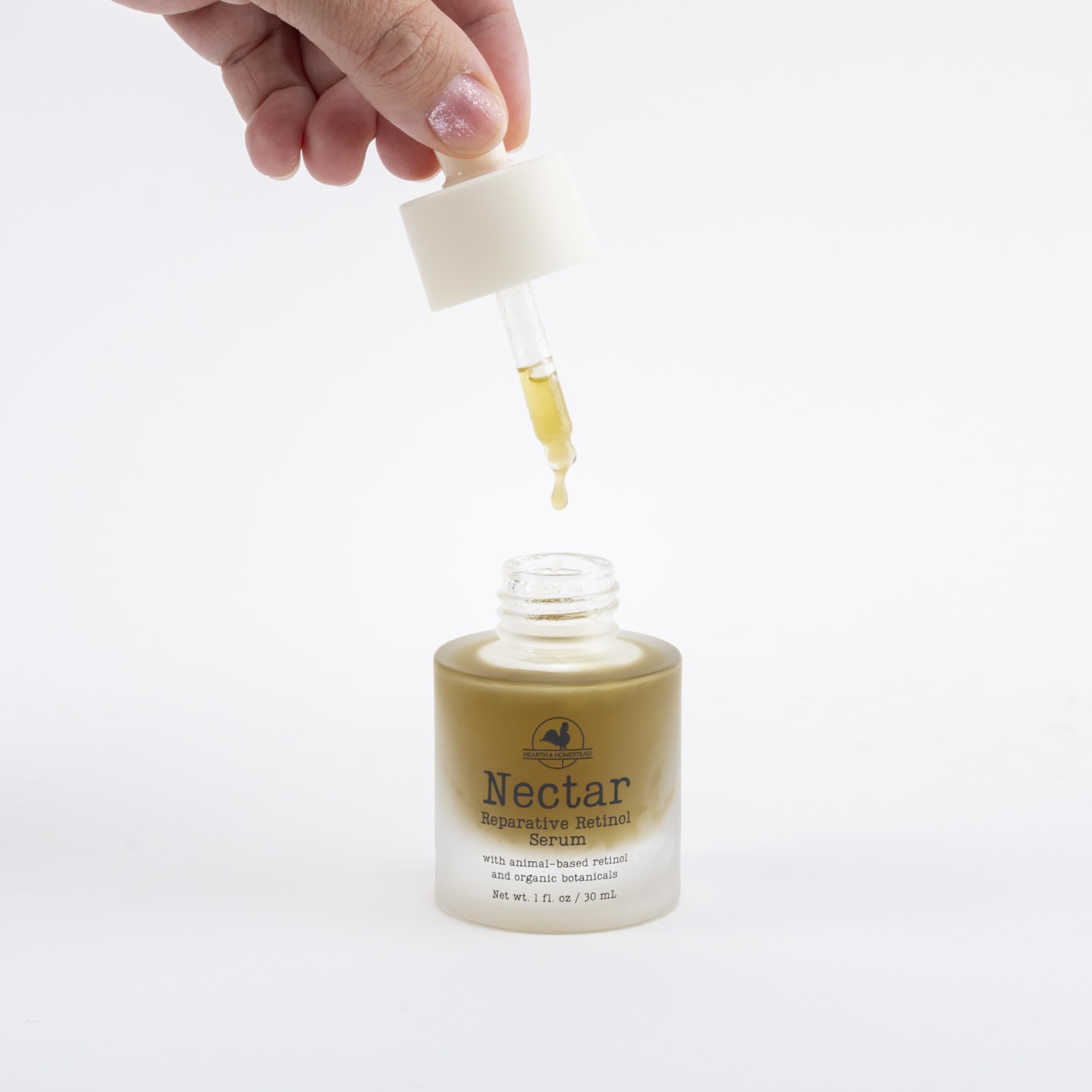 Hearth and Homestead Nectar Serum dropper delivering precise, lightweight hydration.