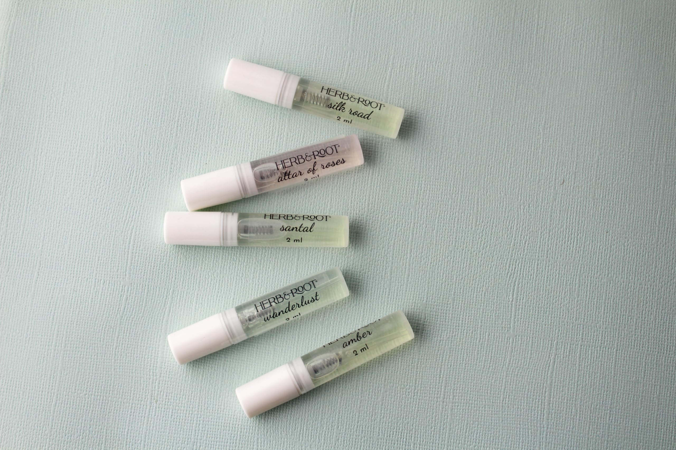 Wanderlust vial with patchouli and frangipani notes for adventurous moments.