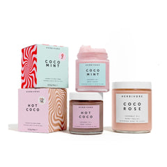 HERBIVORE Coco Mint Body Scrub bottle in hand demonstrates easy body exfoliation and hydration.