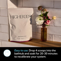 HigherDOSE relaxing essential oils bottle releasing calming aroma in a spa setting.