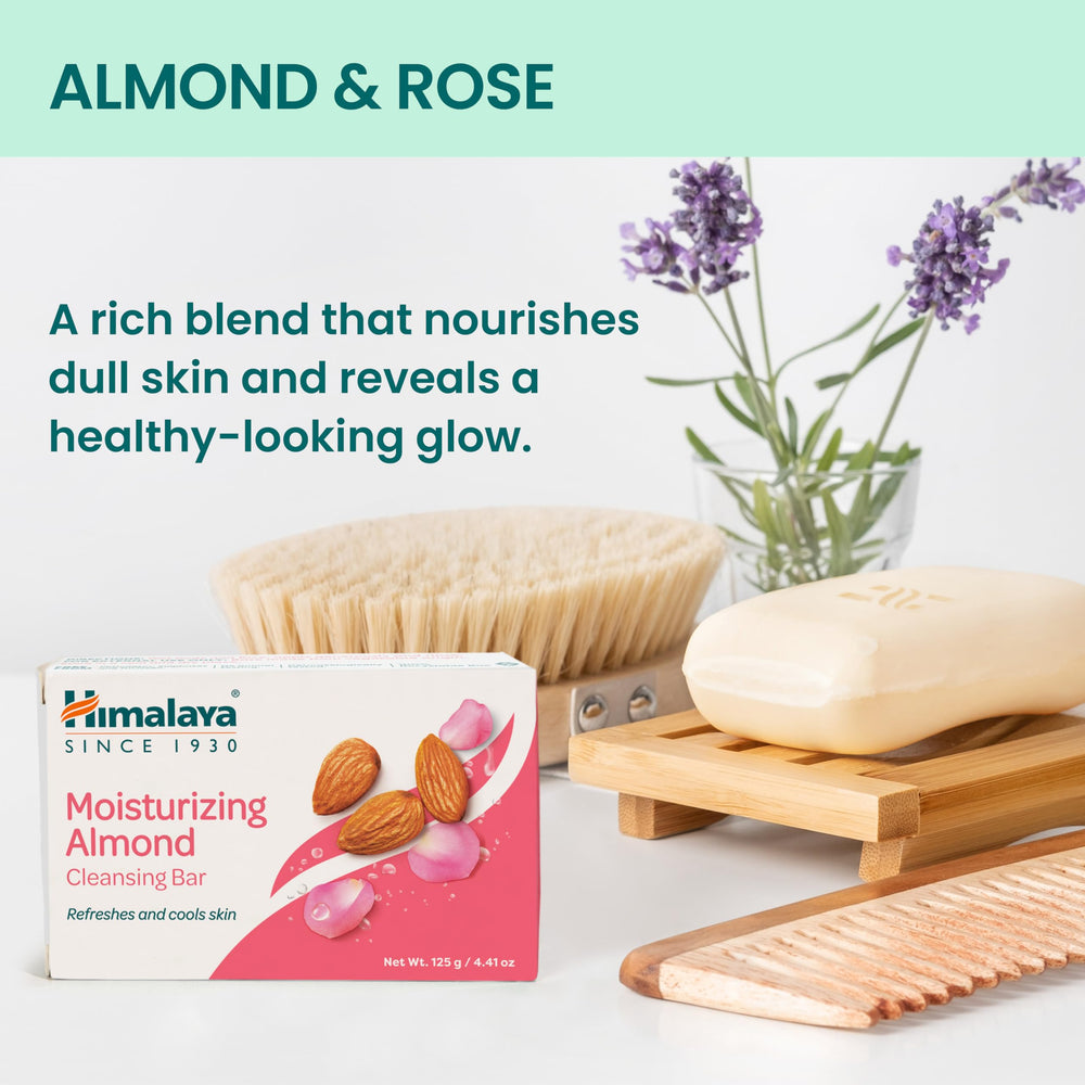 Himalaya almond cleansing bar hand application for smooth skin feel.