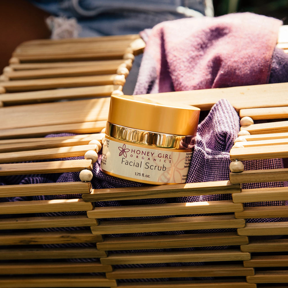 Honey Girl Organics applying the scrub demonstrates routine-based pampering.