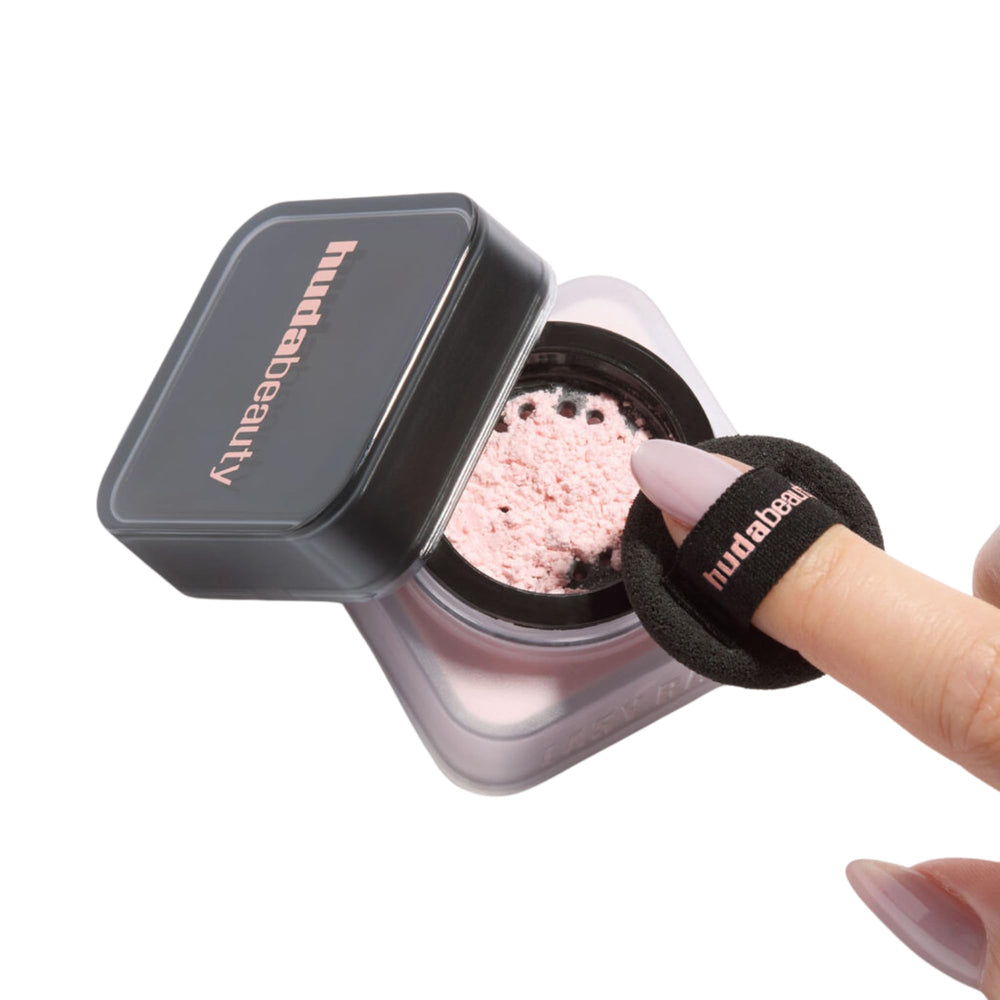 Huda Beauty Baby Bake Mini applying powder with puff for set look