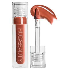 Huda Faux Filler Extra Shine Foxy application close-up for smooth, hydrated lips.