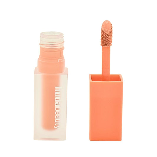 Huda Beauty under-eye color corrector in Pink Pomelo brightens and neutralizes dark circles.