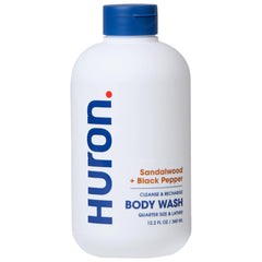 Huron men’s body wash bottle pouring for a refreshing cleanse and woody aroma