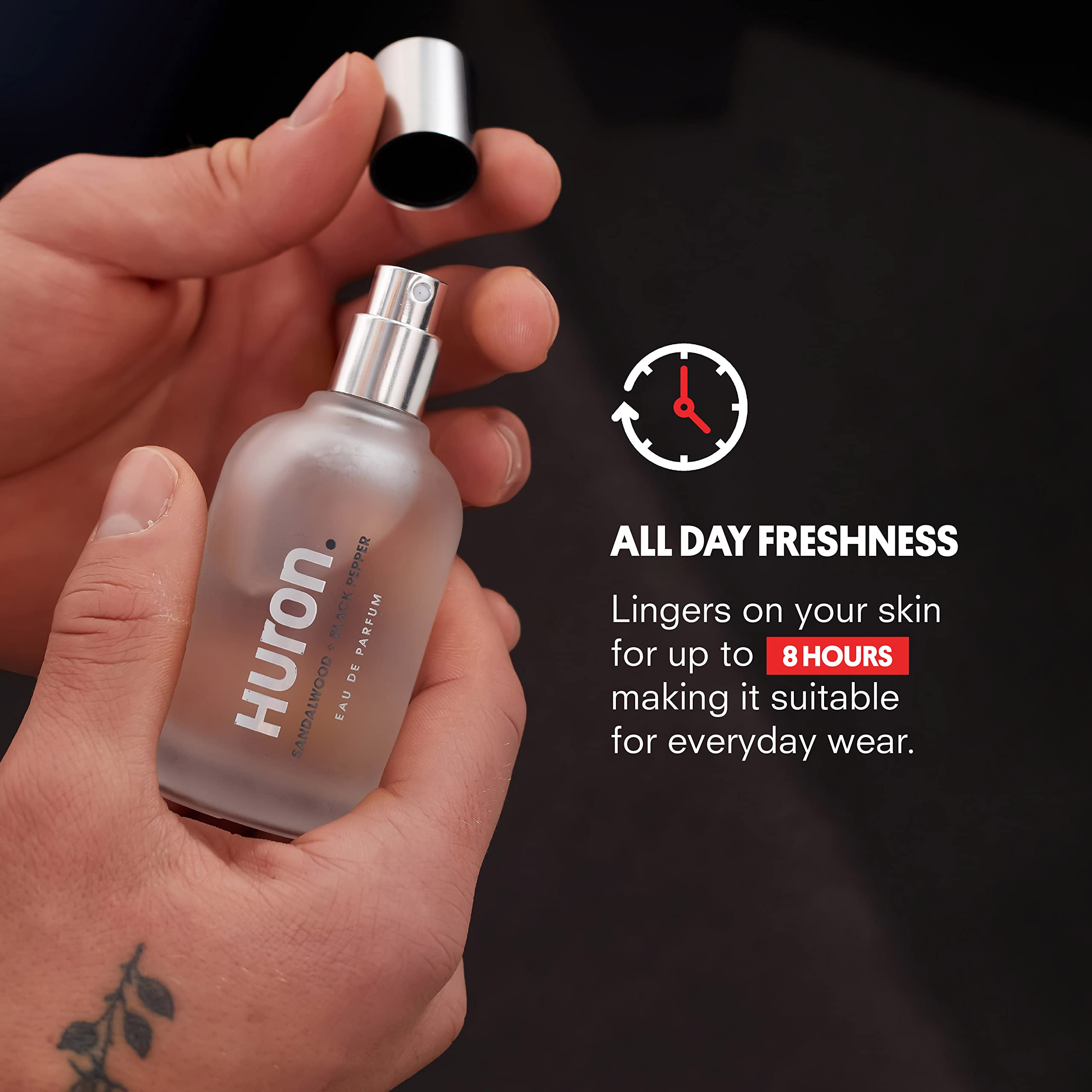 Lit glass bottle of Huron Men's Cologne evokes warm, inviting ambience
