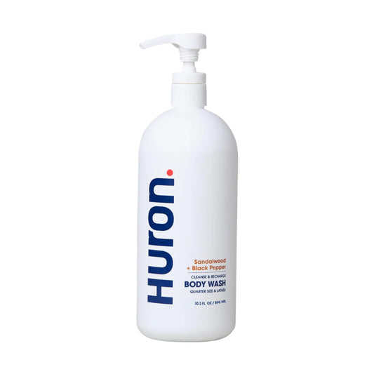 Huron Men's Moisturizing Body Wash bottle promoting clean hydration with woody notes.