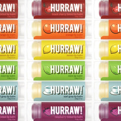 Hurraw! Orange lip balm with bright citrus scent and lightweight moisture.