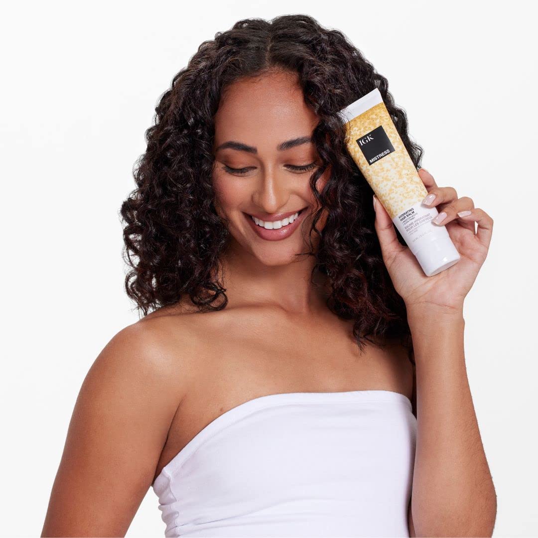 IGK Mistress balm texture shown during application delivers frizz control and smoothness.