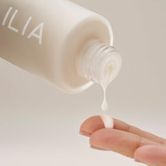 ILIA Base Face Milk Essence skin barrier visual suggests protective support
