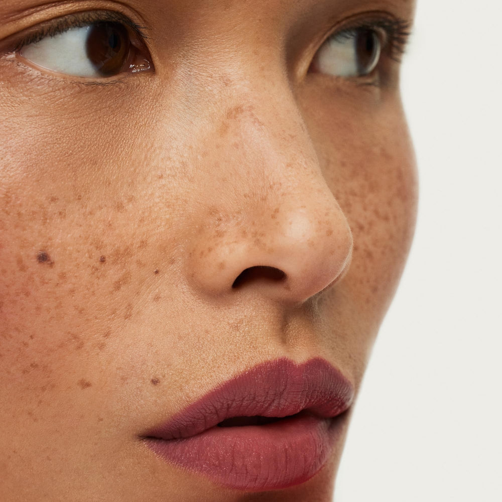 ILIA Lip Sketch Hydrating Crayon on lips with a soft-matte finish.