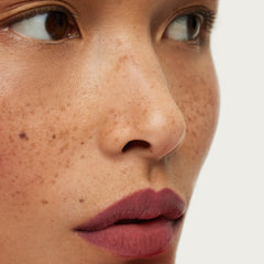 ILIA Lip Sketch Hydrating Crayon on lips with a soft-matte finish.