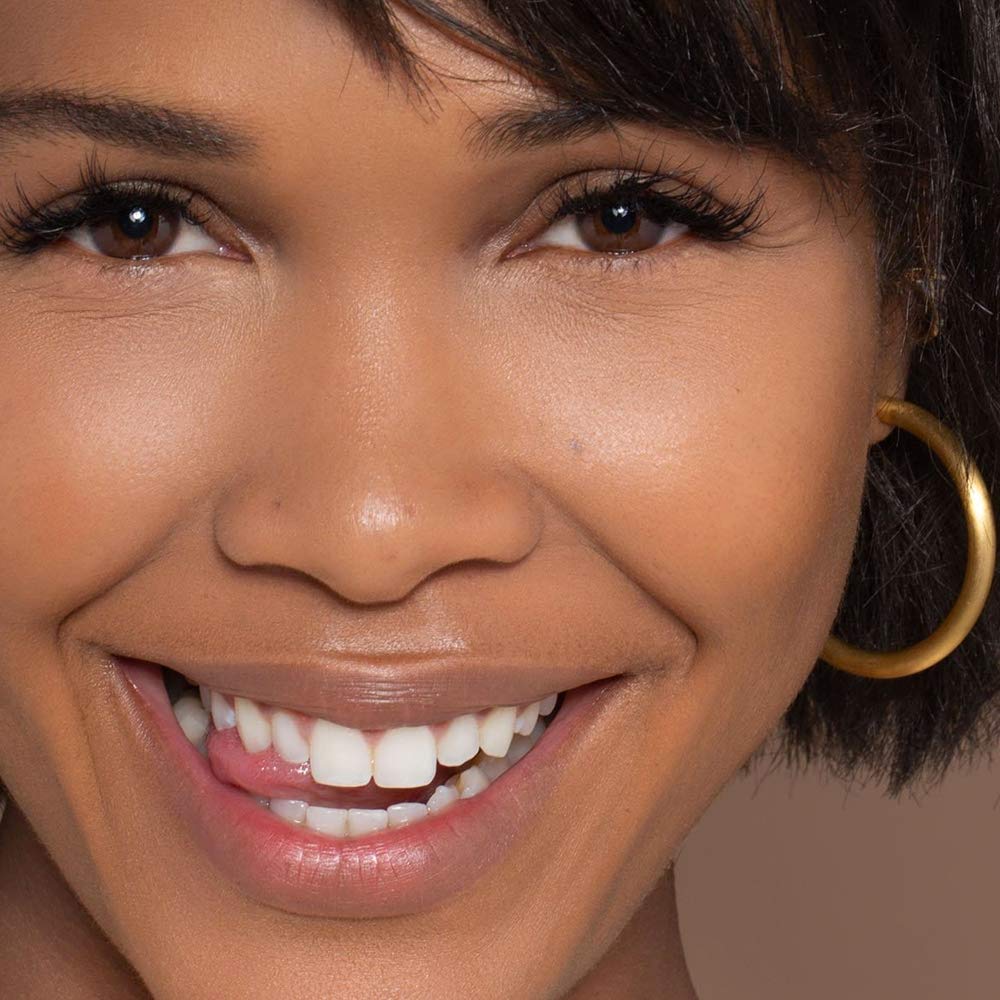 Fingertip application of ILIA True Skin Serum Foundation for seamless blend.