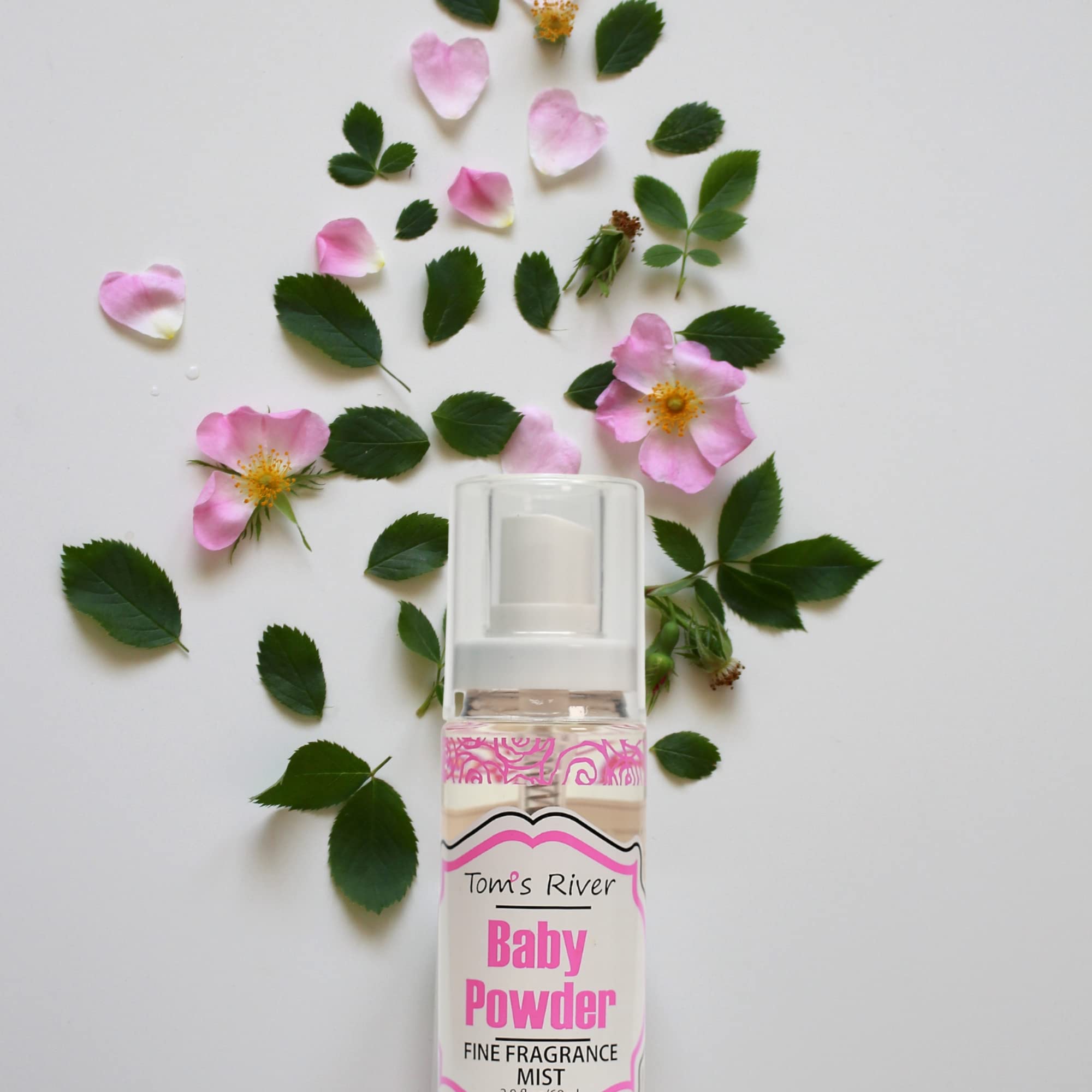 Infinix Baby Fresh Powder Mist being spritzed on the wrist.
