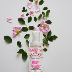 Infinix Baby Fresh Powder Mist being spritzed on the wrist.