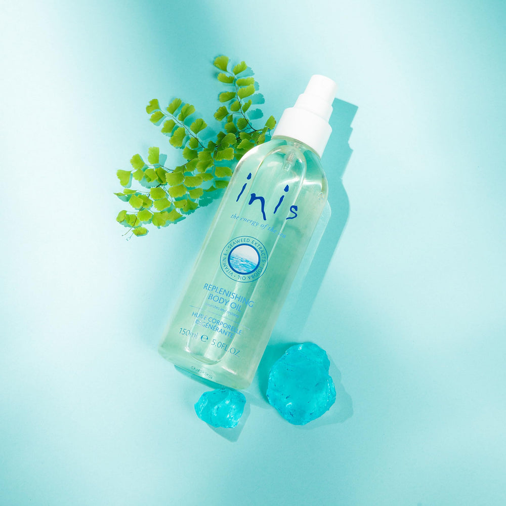 Application of Inis oil on skin showing a silky, non-greasy feel.