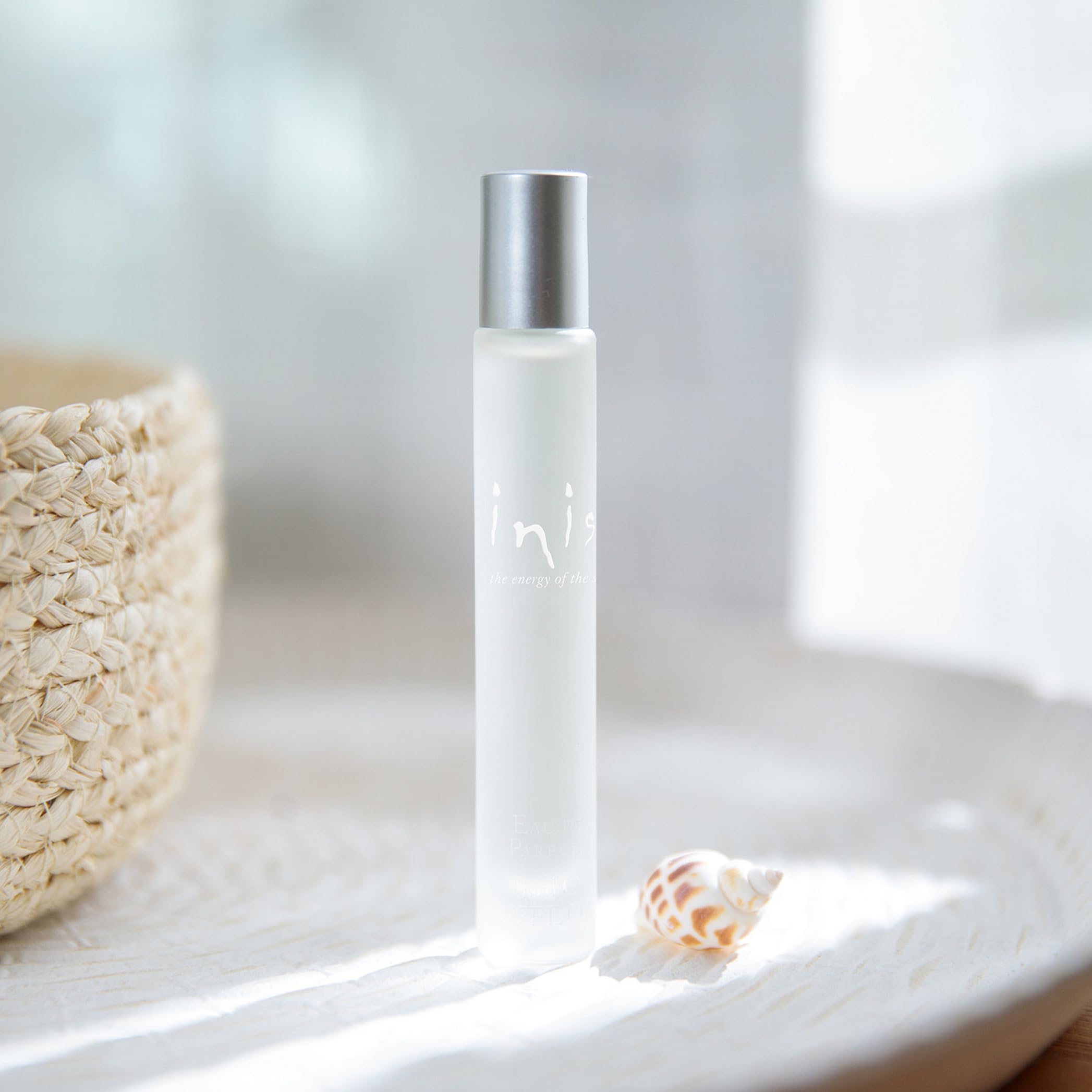 Inis roll-on application close-up shows travel-friendly perfume for on-the-go refresh