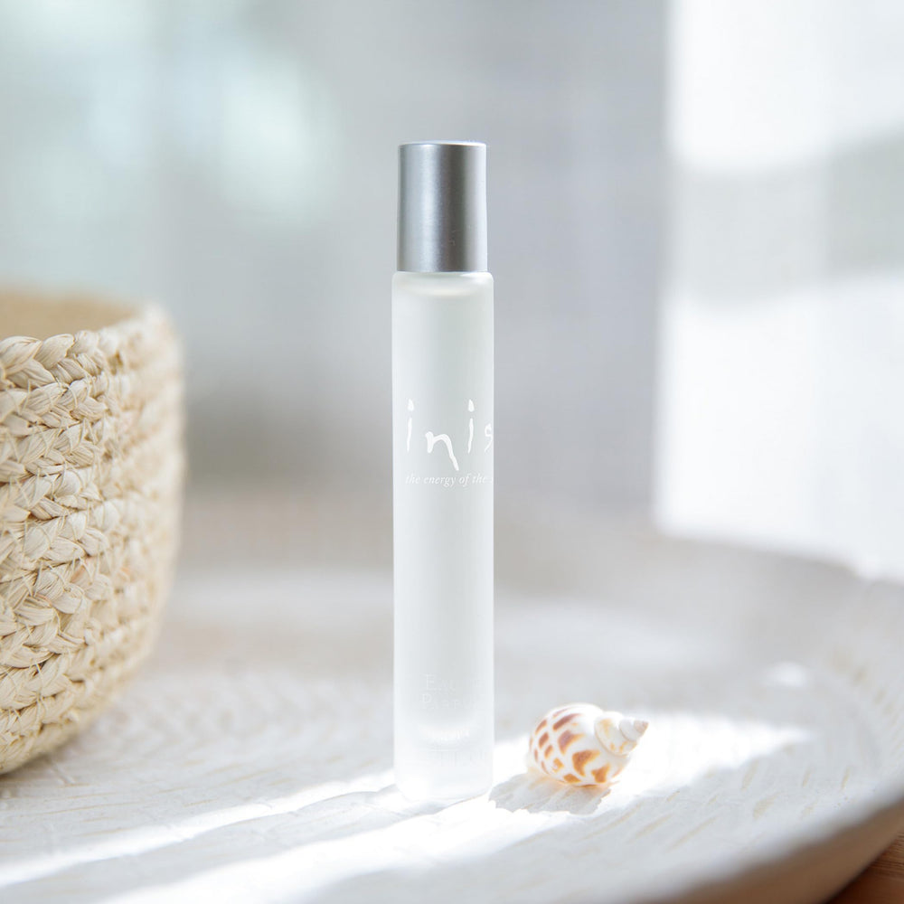 Inis roll-on application close-up shows travel-friendly perfume for on-the-go refresh