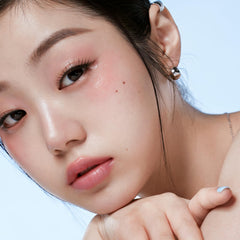 INTO YOU blush stick swatch on cheek demonstrates blendable color and glow