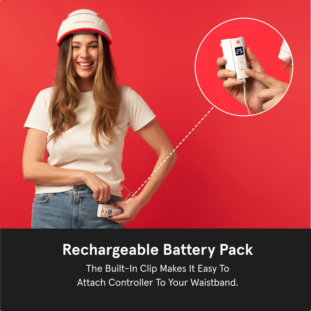 iRestore battery pack clipped to waistband for hands-free treatment.