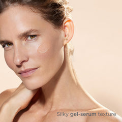 Hand applying Melaclear Advanced gel-serum to the face after cleansing