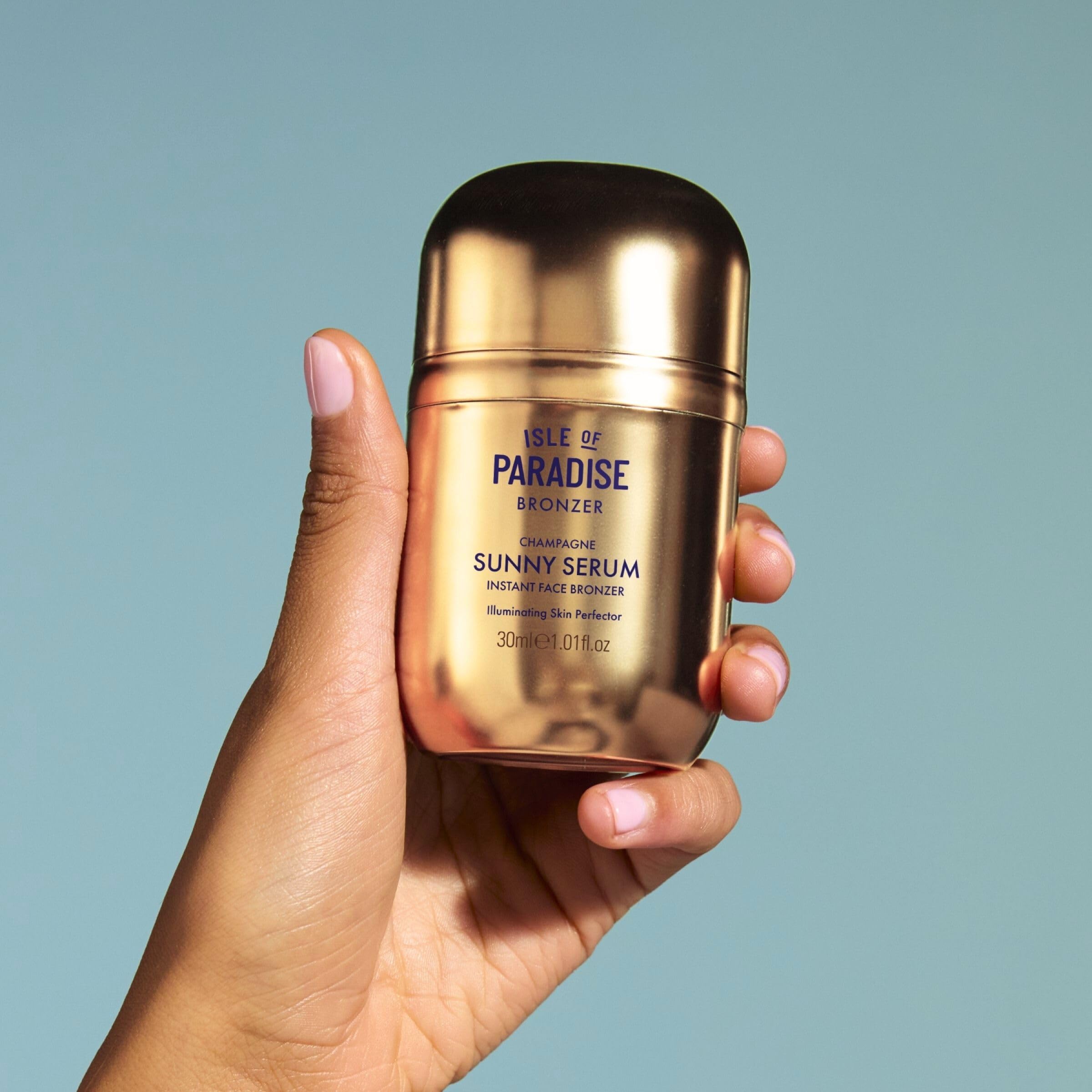 Isle of Paradise Sunny Serum Champagne packaging and pump for travel-friendly use.