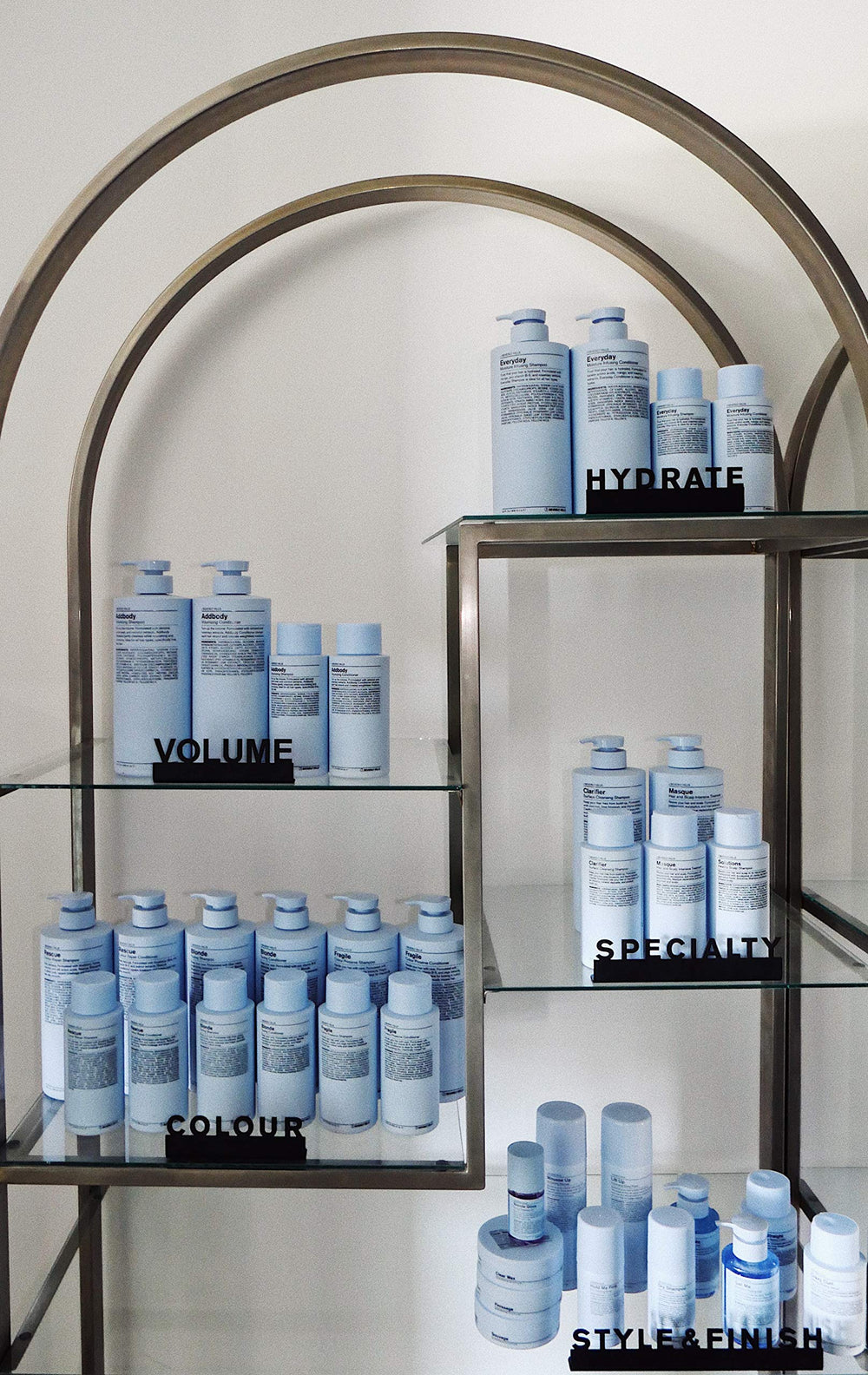 J Beverly Hills Blue Bodifier spray application shows even mist for added fullness.