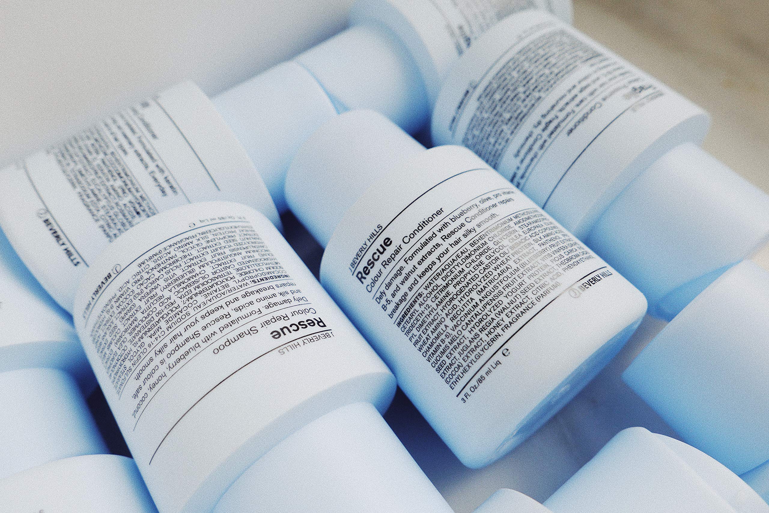 J Beverly Hills Blue Rescue Shampoo bottle closeup highlights moisturizing formula for silky hair.