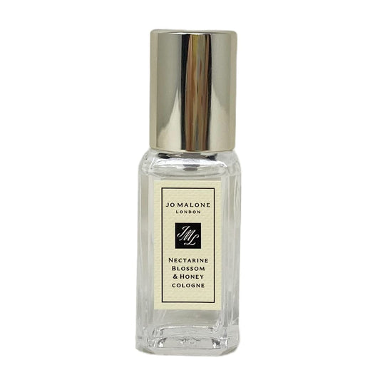 Jo Malone Nectarine Blossom & Honey travel-size bottle, showcasing fruity-floral scent for day wear.