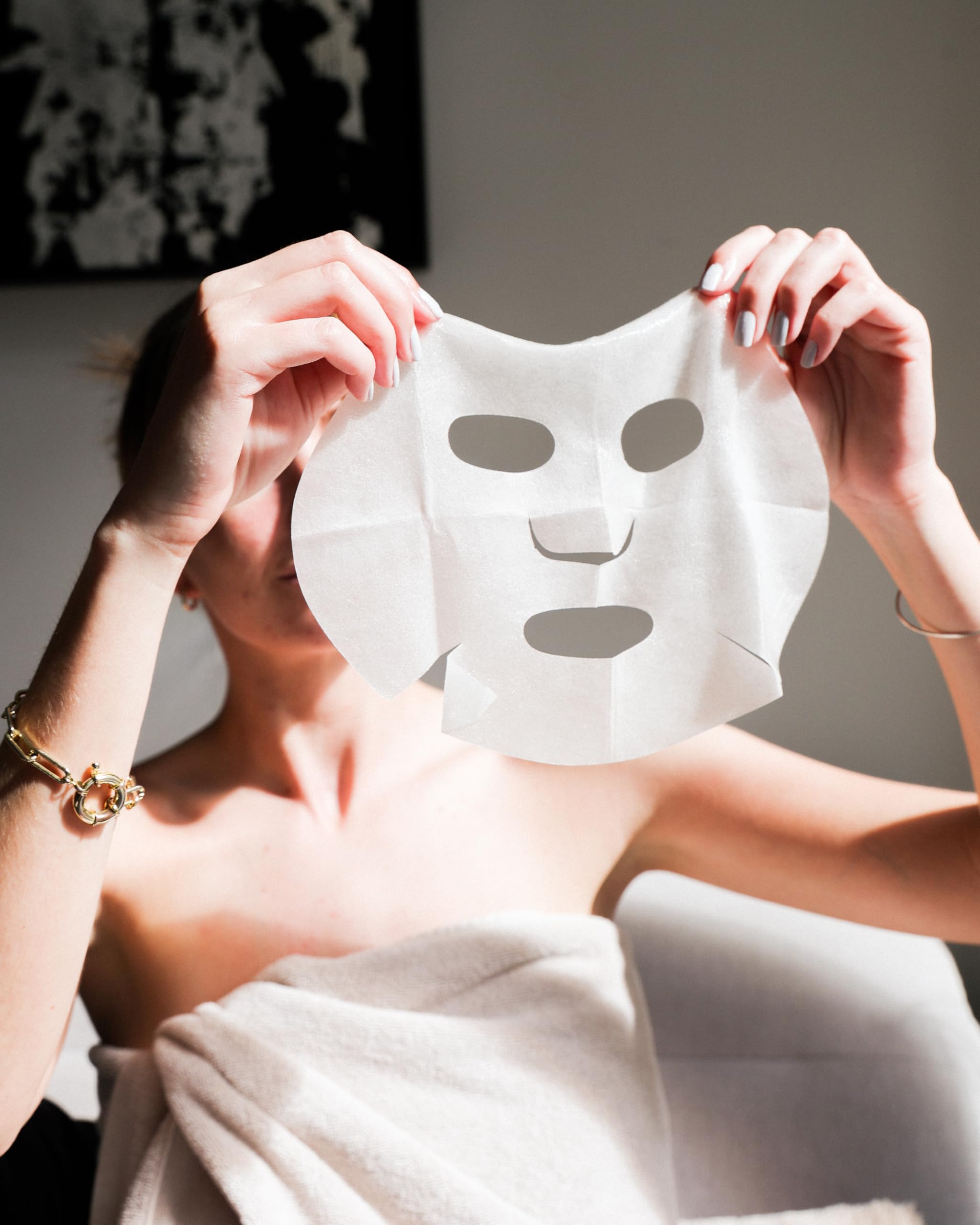 Sheet mask resting on skin showing comfortable fit and essence absorption.