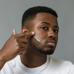 Johnny B shave cream tube helps prevent razor burn during use.