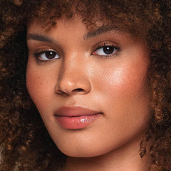 Jouer Essential Vegan Lip Enhancer on lips with sheer tint for subtle color.